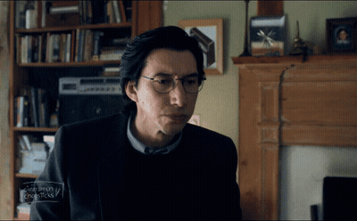 Man With Glasses Sitting By Fireplace GIF