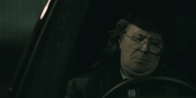 Man With Glasses Sitting In Dark Car GIF