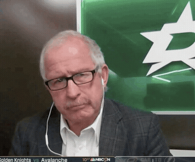 Man With Glasses Sitting In Front Of Green Board With Star GIF