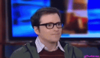 Man With Glasses Sitting In Front Of TV GIF