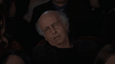 Man With Glasses Sleeping On Woman's Lap In Dark Room GIF