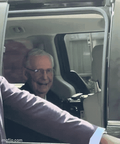 Man With Glasses Smiling in Car