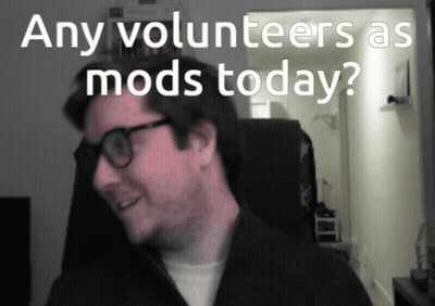 Man With Glasses Smiling In Front Of Any Volunteers As Mods Today Sign GIF