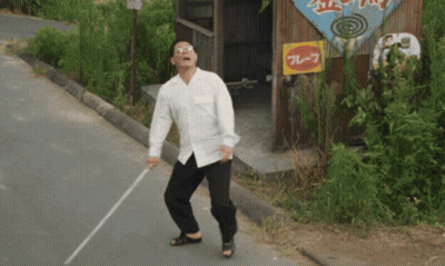 Man With Glasses Smoking Cigarette In Dark Room GIF