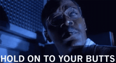 Man With Glasses Smoking Cigarette In Dark Room GIF