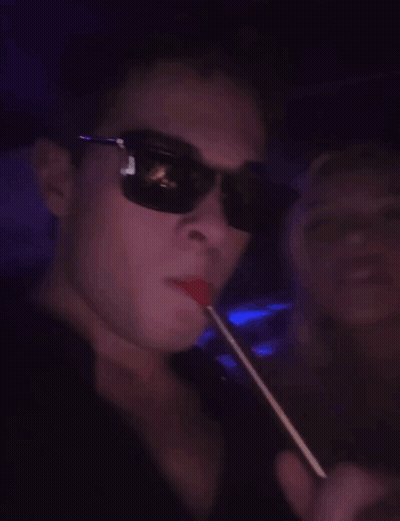 Man With Glasses Smoking Hookah In Dark Room GIF