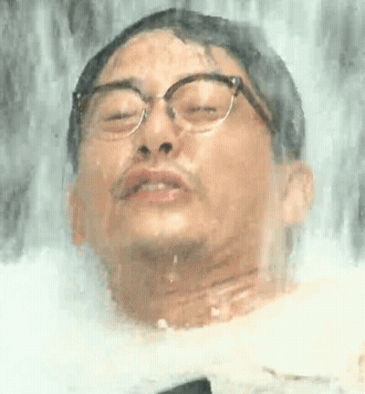 Man With Glasses Standing At Waterfall GIF