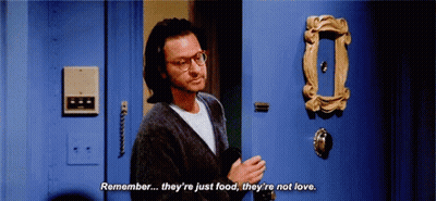 Man With Glasses Talking In Front Of Blue Door GIF