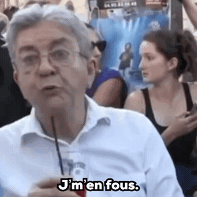 Man With Glasses Talking To Crowd Holding Straw GIF