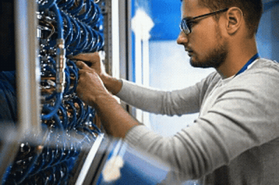 Man With Glasses Working On Server In Data Center GIF