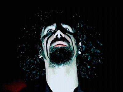 Man With Glowing Eyes And Necklace GIF
