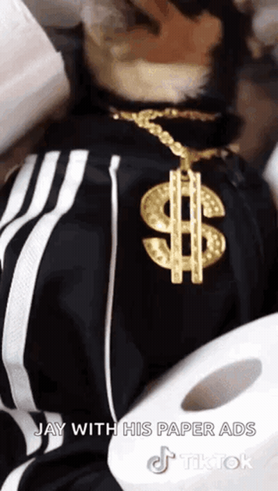 Man With Gold Dollar Sign Necklace Next To Toilet Paper Roll GIF