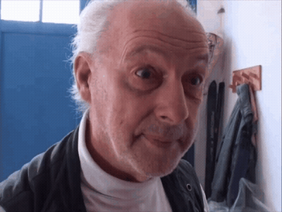 Man With Gray Hair And Beard Looking At Camera GIF