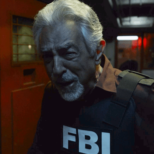Man With Gray Hair And Beard Wearing FBI Vest GIF