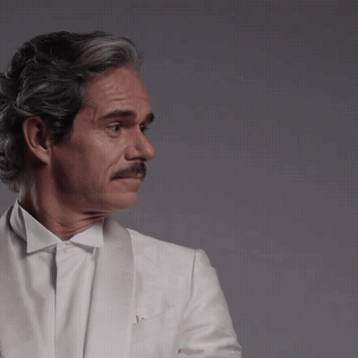 Man With Gray Hair And Mustache In White Jacket GIF