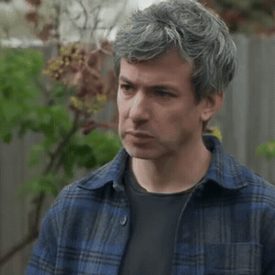 Man With Gray Hair in Blue Plaid and Black Shirt
