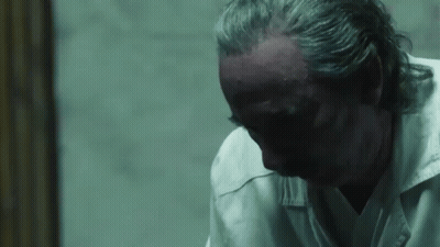 Man With Gray Hair Looking Down GIF