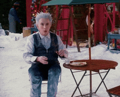 Man With Gray Hair Sitting At Table With Food GIF