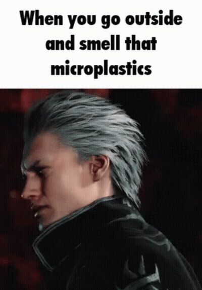 Man With Gray Hair Smelling Microplastics In Dark GIF