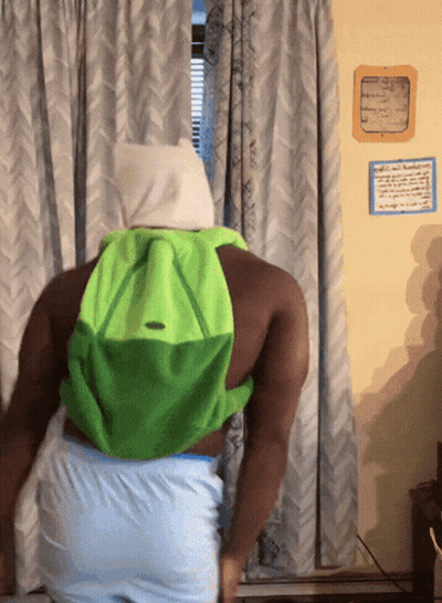 Man With Green Backpack In Front Of Window GIF