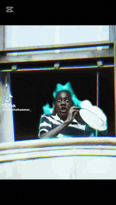Man With Green Bow Looking Out Window GIF