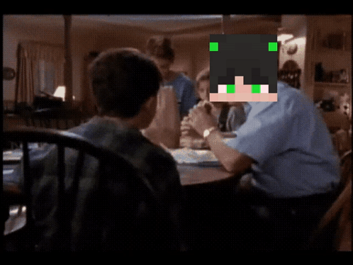 Man With Green Eyes Sits At Table With Children GIF