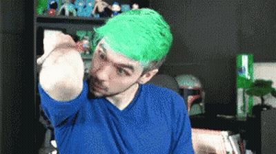 Man With Green Hair And Blue Shirt Holding Something GIF