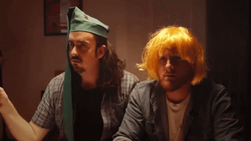 Man With Green Hat And Man With Yellow Hair GIF