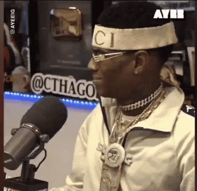 Man With Gucci Headband Sitting At Microphone GIF