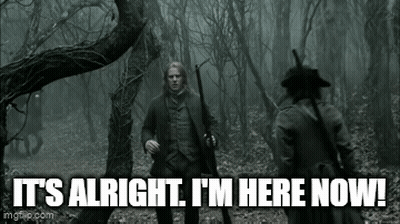 Man With Gun Standing In Woods GIF