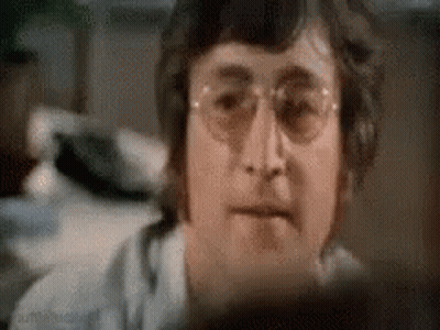 Man With Hammer On Head Looks At Camera GIF