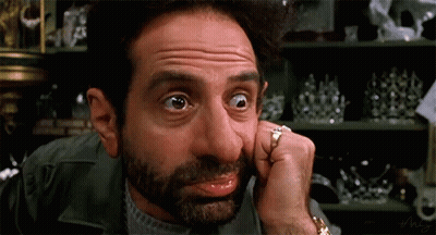 Man With Hands Behind Head In Front Of Emergency Monitor GIF