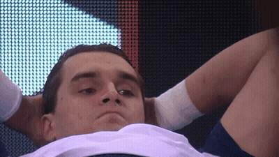 Man With Hands Behind Head Looking Down GIF