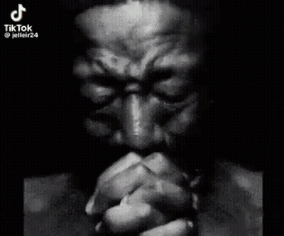 Man With Hands Folded In Front Of Face GIF