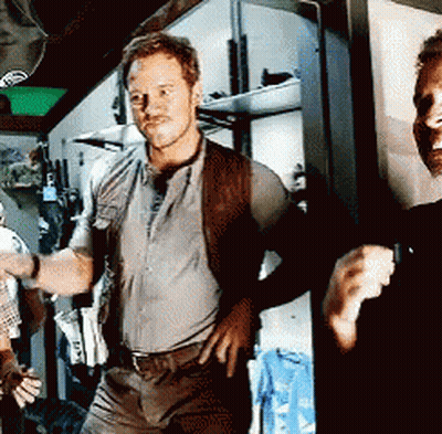 Man With Hands On Hips Next To Man In Black Shirt GIF
