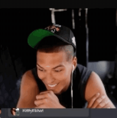Man With Hat And Earbuds Sticking Out Tongue GIF