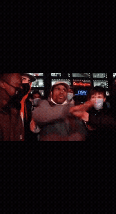 Man With Hat And Headphones Surrounded By People GIF
