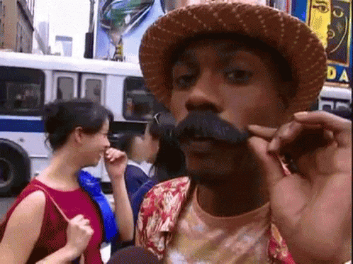 Man With Hat And Mustache Talking To Woman GIF