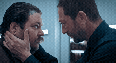 Man With Head Tattoo Looking At Another Man GIF
