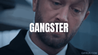 Man With Head Tattoo Looking At Another Man GIF