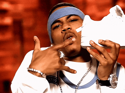 Man With Headband And Watch Holding White Shoe GIF