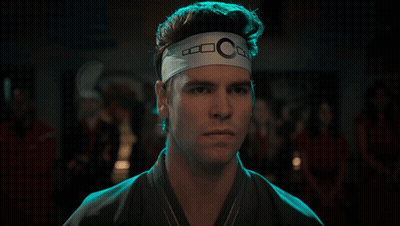 Man With Headband Letter C Looking At Camera GIF