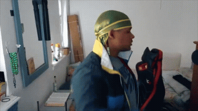 Man With Headband Letter T In Front Of Mirror GIF