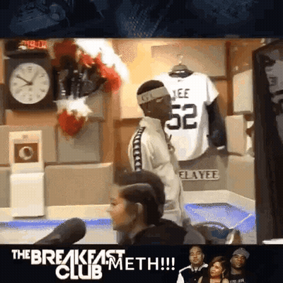 Man With Headband Number 52 In Front Of Clock GIF