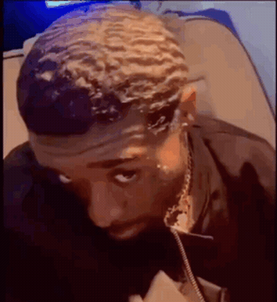 Man With Headband Sitting And Looking Down GIF