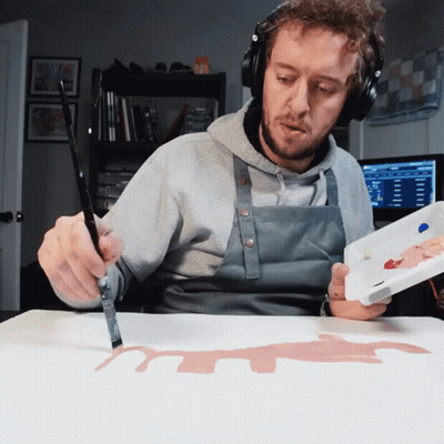 Man With Headphones And Apron Holding Palette And Brush GIF
