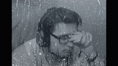 Man With Headphones And Glasses Looking Out Window GIF