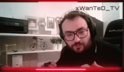 Man With Headphones And Glasses On Wanted TV Screen GIF