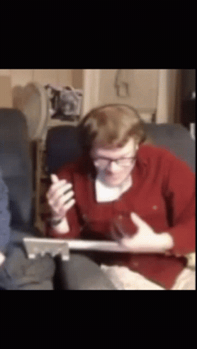 Man With Headphones And Glasses Sitting On Couch With Laptop GIF