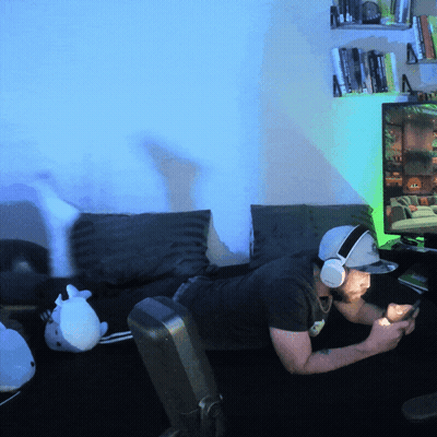 Man With Headphones And Hat Lying On Couch GIF